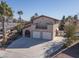 Two-story house with a large driveway and attached garage at 2005 University Cir, Las Vegas, NV 89119