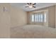 A spacious main bedroom featuring a ceiling fan and window shutters at 2101 Desert Woods Dr, Henderson, NV 89012