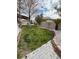 Spacious backyard with grassy lawn, stone accents, and a mature tree at 2621 Slide Canyon Ave, North Las Vegas, NV 89081