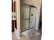 Shower with glass enclosure and neutral tile at 2621 Slide Canyon Ave, North Las Vegas, NV 89081
