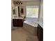 Bathroom with corner bathtub and double sinks at 2621 Slide Canyon Ave, North Las Vegas, NV 89081