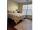 Bright bedroom with a king-size bed and wood flooring at 2621 Slide Canyon Ave, North Las Vegas, NV 89081