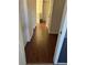 Long hallway with hardwood floors and multiple doors at 2621 Slide Canyon Ave, North Las Vegas, NV 89081