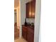 Butlers pantry with wood cabinets and granite countertop at 2621 Slide Canyon Ave, North Las Vegas, NV 89081