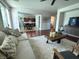 Spacious living room features hardwood floors, comfortable seating, and a large TV at 2621 Slide Canyon Ave, North Las Vegas, NV 89081