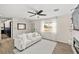 Bright living room with a ceiling fan, window, and fireplace at 2931 Rodeo Ave, Pahrump, NV 89048