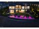 Luxury home with a large pool, beautifully lit at night at 30 Olympia Outlook Dr, Las Vegas, NV 89141