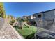 Large backyard with playset, trampoline and artificial turf at 319 Cooper Hawk Ct, Las Vegas, NV 89138