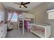 Charming bedroom with a loft bed, crib and built-in shelving at 319 Cooper Hawk Ct, Las Vegas, NV 89138
