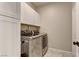 Bright laundry room with upper cabinets and modern appliances at 319 Cooper Hawk Ct, Las Vegas, NV 89138