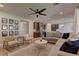 Open living space with a large sectional sofa and hardwood floors at 319 Cooper Hawk Ct, Las Vegas, NV 89138