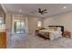Large main bedroom with private balcony access and ceiling fan at 319 Cooper Hawk Ct, Las Vegas, NV 89138
