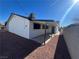 House exterior showcasing a covered patio and gravel landscaping at 3600 Broadway Ave, North Las Vegas, NV 89030