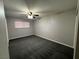 Well-lit bedroom with ceiling fan and grey carpeting at 3600 Broadway Ave, North Las Vegas, NV 89030