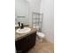 Half bathroom featuring a vanity with granite countertop, and shelving next to the toilet at 3891 Terrazzo Ave, Las Vegas, NV 89115