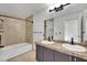 Bathroom features a double vanity with granite countertops and tiled shower over tub at 3891 Terrazzo Ave, Las Vegas, NV 89115
