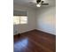 This cozy bedroom offers hardwood floors and ample natural light from the window at 3891 Terrazzo Ave, Las Vegas, NV 89115