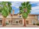 Inviting multi-Gathering home featuring stucco siding and desert landscaping, complemented by mature palm trees and a blue sky at 3891 Terrazzo Ave, Las Vegas, NV 89115