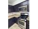 Kitchen with modern stainless steel appliances and dark cabinets at 3891 Terrazzo Ave, Las Vegas, NV 89115