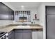 Bright kitchen featuring granite countertops, stainless steel dishwasher, and a window with a cheerful curtain at 3891 Terrazzo Ave, Las Vegas, NV 89115