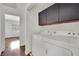 Upstairs laundry nook featuring a washer and dryer, with views into the main bedroom at 3891 Terrazzo Ave, Las Vegas, NV 89115
