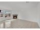Bright living room boasts tile floors, a charming fireplace, and multiple windows offering natural light at 3891 Terrazzo Ave, Las Vegas, NV 89115