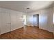 Simple bedroom with wood flooring and built-in closet at 4413 Buckeye Ave, Las Vegas, NV 89102