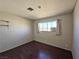 Cozy bedroom with dark wood floors and a window with curtains at 4413 Buckeye Ave, Las Vegas, NV 89102