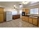 Kitchen with wood cabinets, appliances, and tiled floor at 4413 Buckeye Ave, Las Vegas, NV 89102