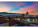 Neighborhood with panoramic city views at dusk at 476 Tiger Lily Way, Henderson, NV 89015