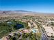 Stunning aerial view of the community with swimming pools, golf course, and mountain views at 5130 Agio Ave, Pahrump, NV 89061