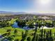 Picturesque aerial view of the community featuring a golf course, pond and lush trees at 5130 Agio Ave, Pahrump, NV 89061
