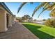 Lush backyard with a patio, artificial turf, and a serene lake view, perfect for outdoor relaxation and entertainment at 5130 Agio Ave, Pahrump, NV 89061