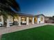 A beautiful backyard, showcasing a covered patio, lush turf, and elegant exterior of the home at 5130 Agio Ave, Pahrump, NV 89061