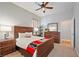 This bedroom features stylish wooden furniture, neutral walls, and a ceiling fan for a comfortable atmosphere at 5130 Agio Ave, Pahrump, NV 89061