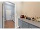 Butler pantry featuring gray cabinets, ample counter space, and convenient access to a door for easy serving at 5130 Agio Ave, Pahrump, NV 89061