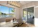 An open dining area features a wooden table with scenic lake view and patio access at 5130 Agio Ave, Pahrump, NV 89061