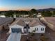 Stunning single-story home boasts a tile roof, desert landscaping, and a serene water view with a golf course backdrop at 5130 Agio Ave, Pahrump, NV 89061
