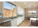 Modern kitchen with white cabinets, granite counters, and breakfast area at 5130 Agio Ave, Pahrump, NV 89061