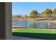 Views of lake and golf course from backyard featuring iron fence and artificial grass at 5130 Agio Ave, Pahrump, NV 89061