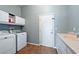 Functional laundry room with washer, dryer, storage cabinets, and a sink for added convenience at 5130 Agio Ave, Pahrump, NV 89061
