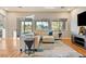 Living room featuring a sectional sofa, expansive windows and backyard views at 5130 Agio Ave, Pahrump, NV 89061
