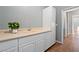 This utility room boasts ample counter space, white cabinetry, and tile flooring for efficient organization at 5130 Agio Ave, Pahrump, NV 89061
