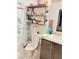 Bathroom with shower, toilet, double vanity, and shelves at 5197 Silica Chalk Ave, Las Vegas, NV 89115