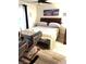 Bedroom with a bed, chairs, and artwork at 5197 Silica Chalk Ave, Las Vegas, NV 89115