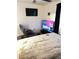 Bedroom with two armchairs, TV, and a comfortable bed at 5197 Silica Chalk Ave, Las Vegas, NV 89115
