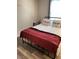Cozy bedroom with a comfortable bed and dark red blanket at 5197 Silica Chalk Ave, Las Vegas, NV 89115