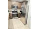 Kitchen with stainless steel appliances and wood cabinets at 5197 Silica Chalk Ave, Las Vegas, NV 89115