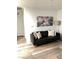 Living room with black couch and modern wall art at 5197 Silica Chalk Ave, Las Vegas, NV 89115