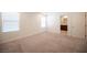 Well-lit bedroom with carpet flooring and access to a full bathroom at 6586 Rustic Saddle Ct, Las Vegas, NV 89141